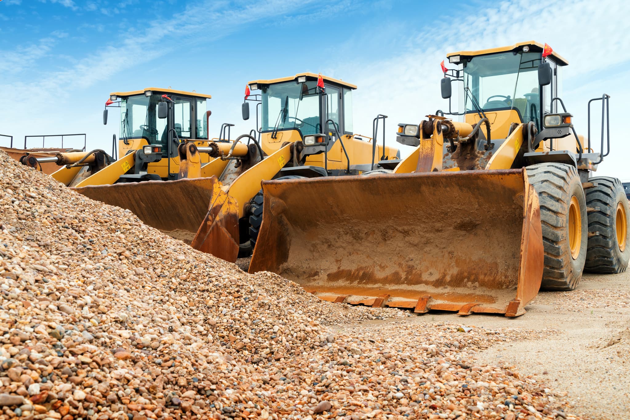 Bulldozers Next to Gravel Pile